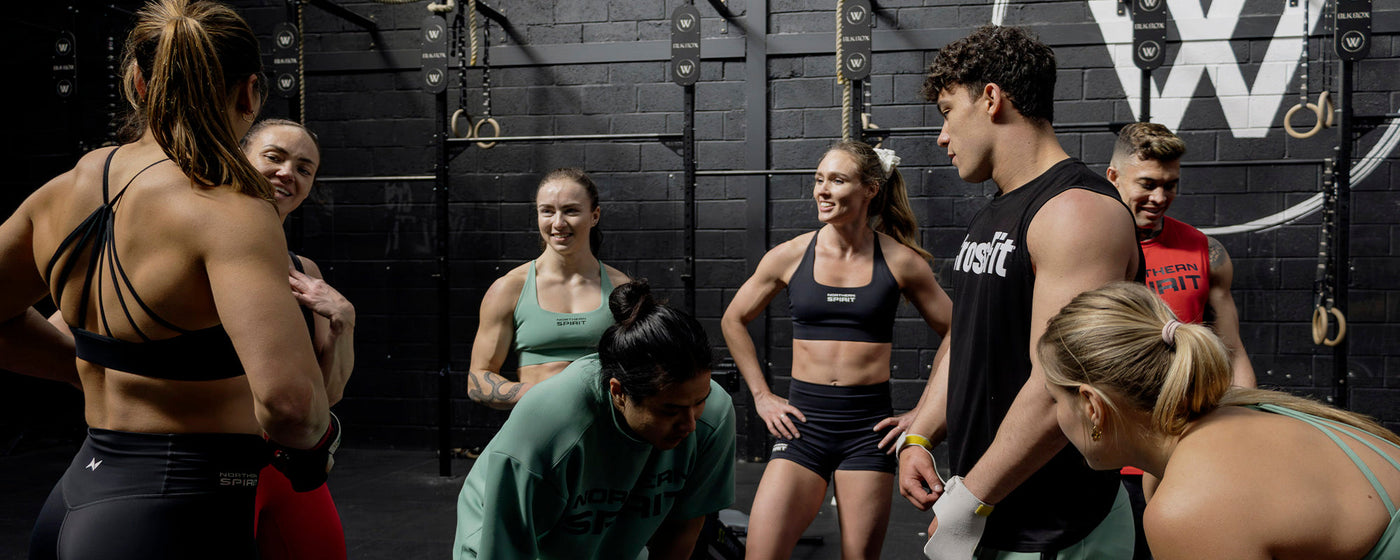 Group of athletes wearing Northern Spirit apparel training together in a CrossFit box — premium functional fitness clothing designed for performance and community.
