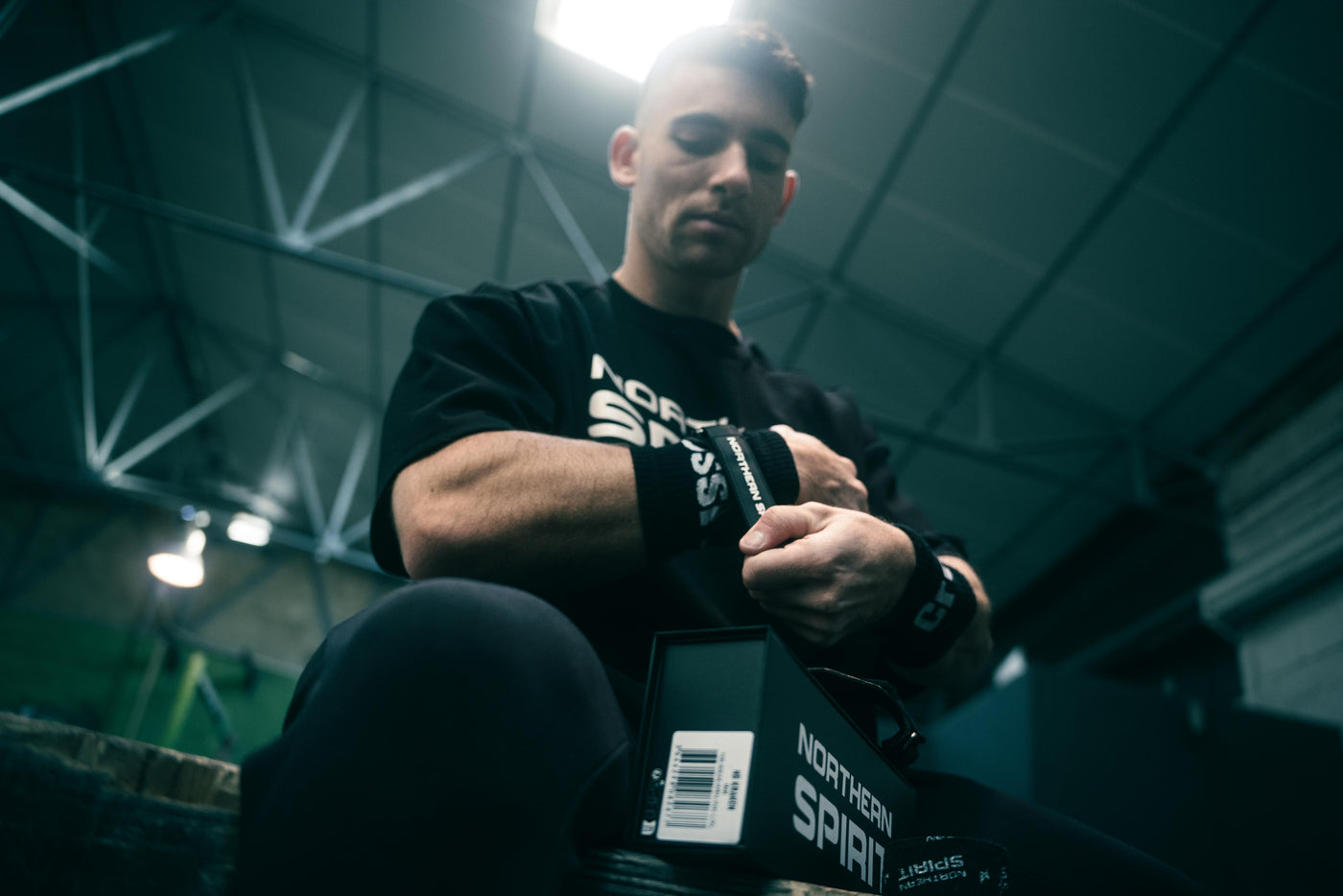 Athlete wearing Northern Spirit T-shirt and wrist wraps before training — premium CrossFit gear designed for performance and support.