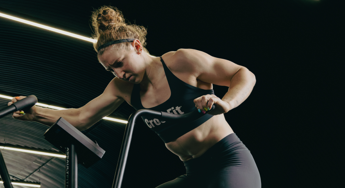Woman exercising on a treadmill in a dark setting