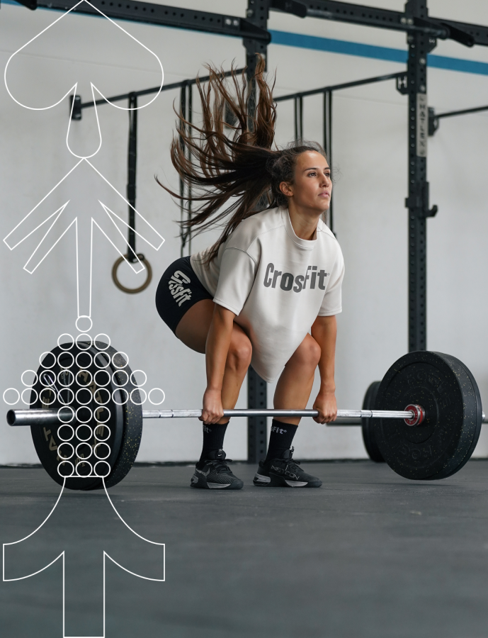 Female athlete performing a deadlift wearing Northern Spirit CrossFit® oversized beige sweatshirt and black shorts for the Women’s Sale campaign.