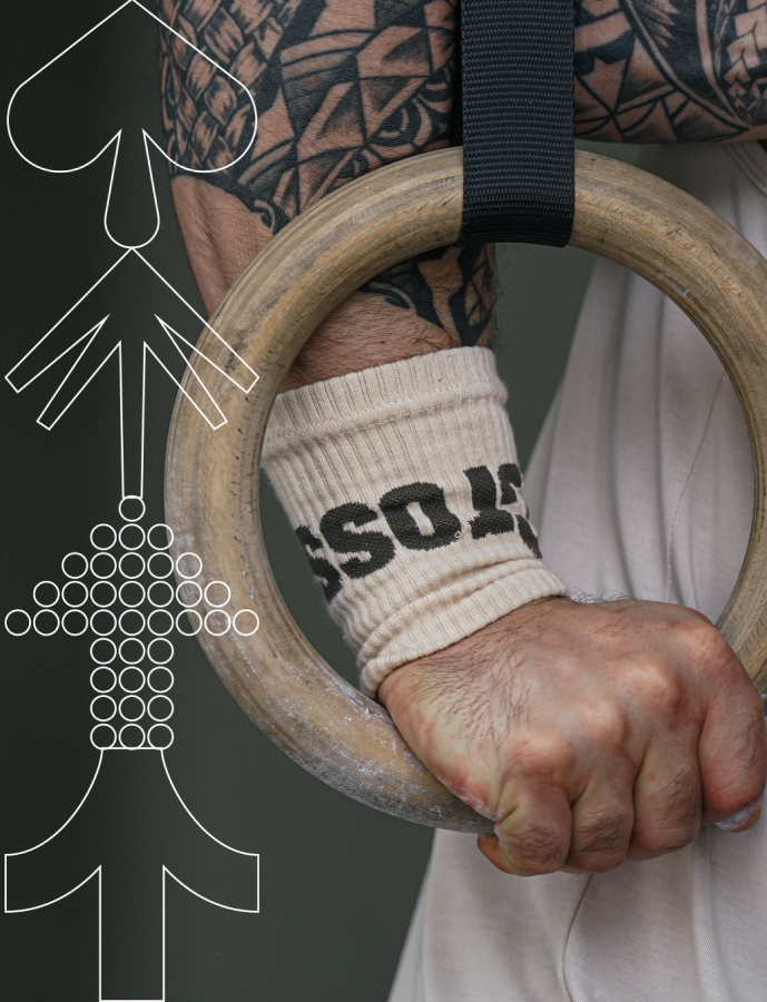 Close-up of athlete gripping wooden gymnastic ring wearing Northern Spirit CrossFit® wrist wraps during the Accessories Sale campaign.